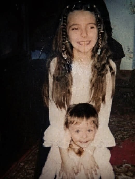 Elena Mihalas as a child with her younger sibling